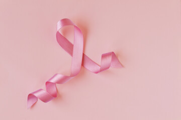 Pink ribbon on pink background - Breast cancer concept