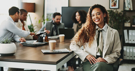 Collaboration, portrait and smile of business woman in boardroom with colleagues for planning. Corporate, face and meeting with happy African employee in professional workplace for career development