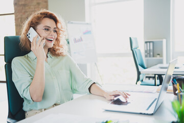 Obraz premium Photo of successful young business lady speak phone use laptop wear shirt modern interior office indoors