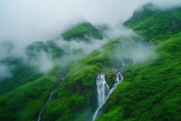 Breathtaking Waterfalls Flowing Through a Misty Green Landscape