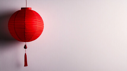 Obraz premium single red paper lantern hanging against white background, minimalistic design