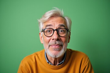 Fototapeta premium Surprised Senior Man in Glasses and Yellow Sweater, Perfect for Advertising, Marketing, or Social Media Campaigns
