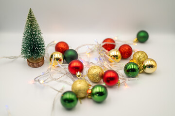 Capture the magic of the holidays with this captivating image of colorful Christmas ornaments nestled amongst twinkling fairy lights. 