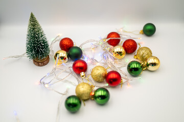 Capture the magic of the holidays with this captivating image of colorful Christmas ornaments nestled amongst twinkling fairy lights. 