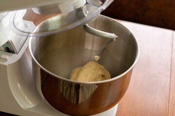 Electric dough mixer machine at the kitchen of bakery. It is mixing dough.