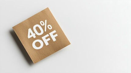 White '40% OFF' Text on a Light Brown Square Paper Note. White Background with Copy Space