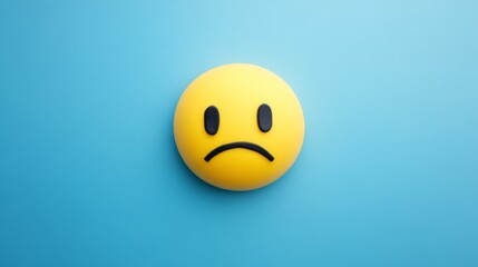 Fototapeta premium Blue Monday Concept with Sad Emoji Face on Light Blue Background