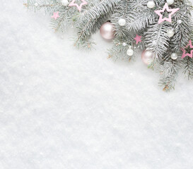 Christmas and New Year background.  Christmas tree branches with  decorations on the background of natural snow with empty space for text.  Flat lay.