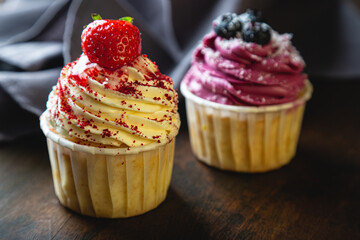 Cupcakes with cream and fresh berries