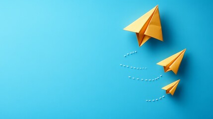 Naklejka premium A paper airplane flies through the air, leaving behind two lines of dotted trails on a blue background.