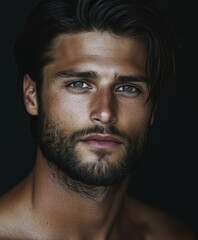 Obraz premium Close-up portrait of a young man with striking features and intense gaze