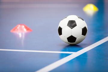 Naklejka premium Soccer Ball and Training Sports Equipment on Indoor Sports Court. Football Futsal Training Equipment. School Sports Practice Background. Indoor Soccer Background