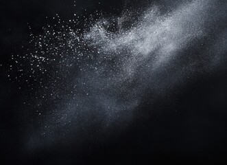 Obraz premium Abstract image of shimmering particles dispersing across a dark background, creating a mystical and ethereal atmosphere ideal for creative projects and designs.