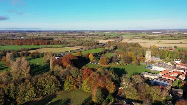 Aerial drone footage of the beautiful town of Bedale which is a market town in the Hambleton former district of North Yorkshire showing the beautiful town, church and motorway in the autumn time
