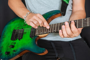 Musician hands skillfully playing electric guitar strings