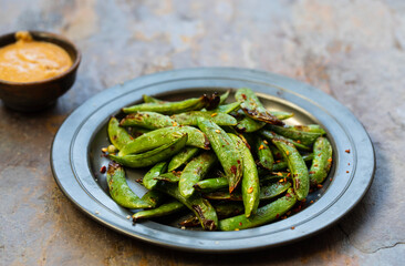 Grilled sugar snap pea with peanut butter sauce