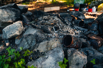 rusty tin cans in a campfire in the Altai