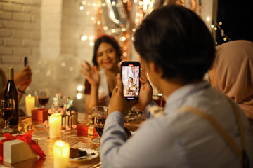 Guests Taking Picture Of Young Girl Having Birthday Party At Home
