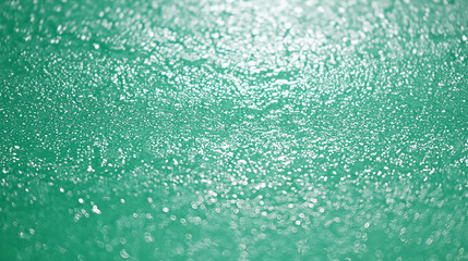 Obraz premium Green abstract texture with shimmering bokeh effect, macro light reflection on surface.