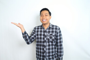 happy asian man presenting hand with smiling face and confident gesture isolated on white backgroun wearing plaid shirt