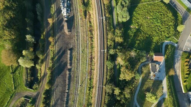 empty railway track line scene under bright sunshine infrastructure's potential for train operations top down birdseye drone view aerial footage 