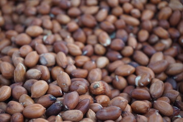 A heap of roasted peeled peanut on a street foodcart, Fresh roasted peanuts selling by a street vendor, A bunch of peeled peanuts.