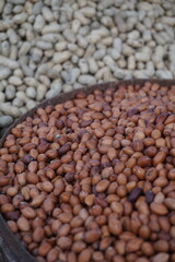 Roasted peanut and bean are being sold on a food cart, A heap of organically produce bean and peanut, Mixed peanuts and bean are selling by a street vendor