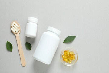 Medicine bottle with pills on a gary background. Fish oil tablets. Biologically active additives. Omega 3, 6, omega 9, vitamin A, E, D,