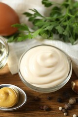 Bowl with mayonnaise and ingredients for cooking on the table 