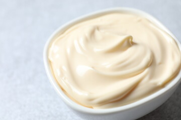 Bowl with mayonnaise and ingredients for cooking on the table 