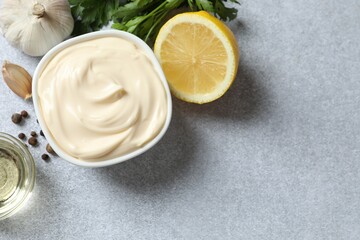 Bowl with mayonnaise and ingredients for cooking on the table 