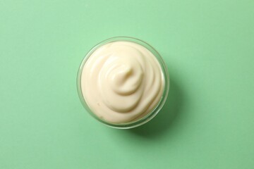 Bowl with mayonnaise and ingredients for cooking on the table 