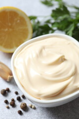 Bowl with mayonnaise and ingredients for cooking on the table 