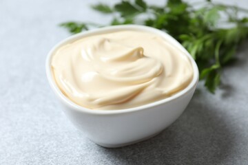 Bowl with mayonnaise and ingredients for cooking on the table 