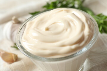 Bowl with mayonnaise and ingredients for cooking on the table 