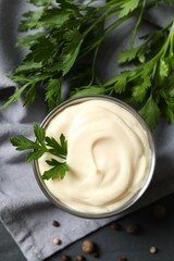 Bowl with mayonnaise and ingredients for cooking on the table 