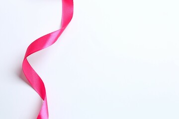 Pink satin ribbon isolated on a white background