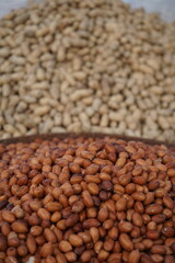 Roasted peanut and bean are being sold on a food cart, A heap of organically produce bean and peanut, Mixed peanuts and bean are selling by a street vendor