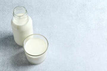 Glass of milk with bottle on the table