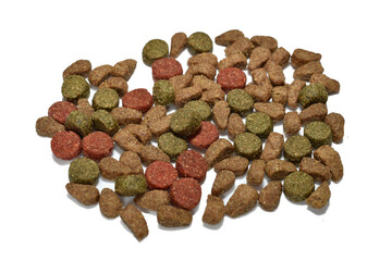 Dry cat food lies on a white background.
