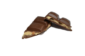 Pieces of chocolate with filling lie on a white background.