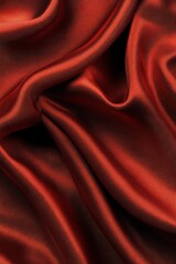 Fototapeta premium Luxurious red satin fabric is perfect for fashion, drapery, and home decor. Its soft texture and vivid color enhance any design, making it an essential material for many applications