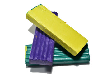 Plasticine for schoolchildren in three shades lies on a PNG background.
