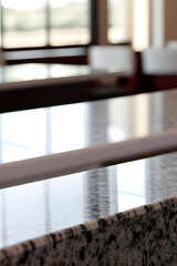 Glass on the granite table, granite counter top on blur of white clean abstract restaurant interior with bokeh. used for display or montage your granite for restaurant background. table banner