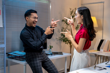 Business people having fun pointing fingers at the office during work