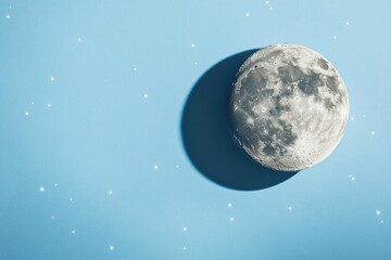 Obraz premium A full moon shining bright in a clear blue sky, great for astronomy or nature scenes