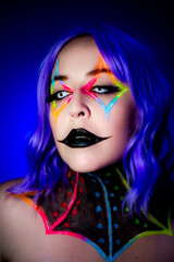 Portrait of a model wearing clown makeup with fluorescent eyewear