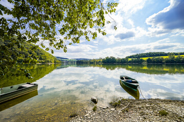 View of the shore of Lake Diemelsee and the surrounding landscape. Idyllic nature by the lake in...