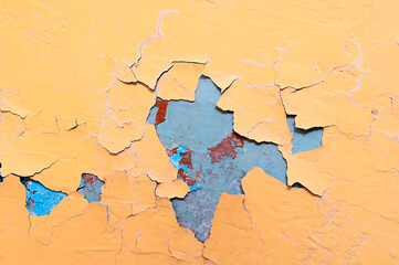 Fototapeta premium Texture background of light orange peeling paint on the old rough surface, texture of peeling paint on the concrete wall