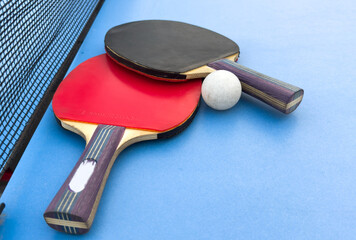 tennis rackets for playing ping pong on blue table, ping pong concept